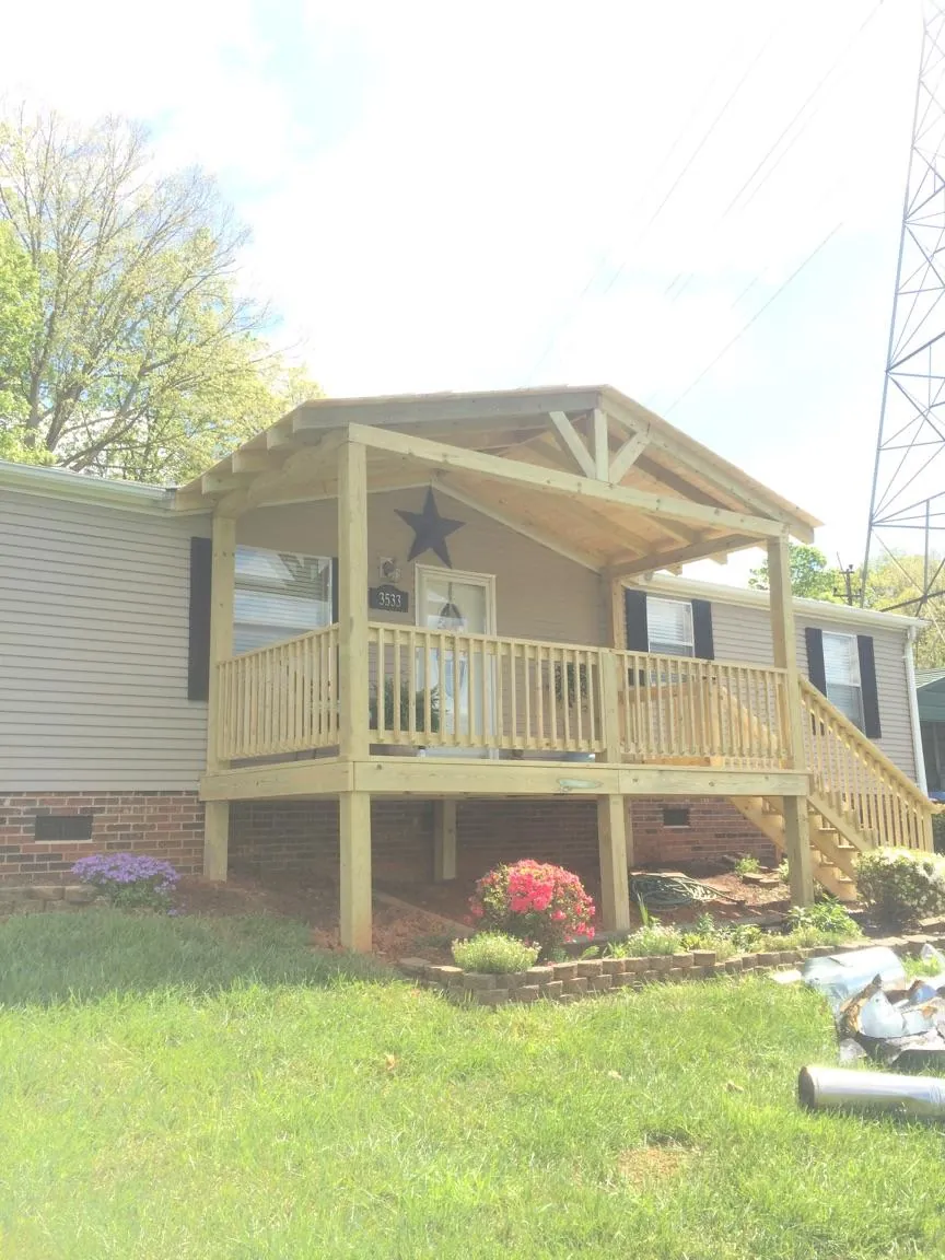 New gabled porch roof and deck railing added to a ranch home in Charlotte Hall